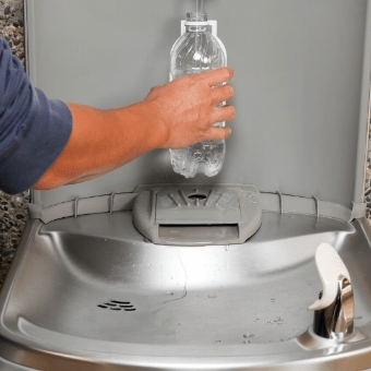 adding water to plastic water bottle
